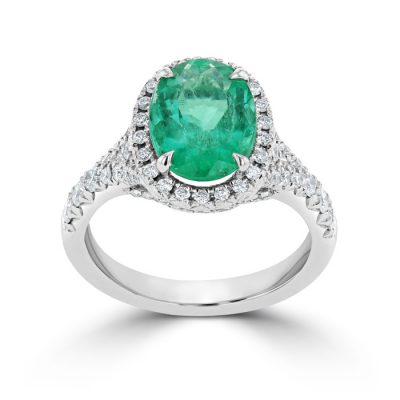 A deep green emerald with a halo setting.