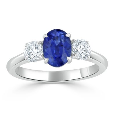 A sapphire ring with two smaller diamonds.